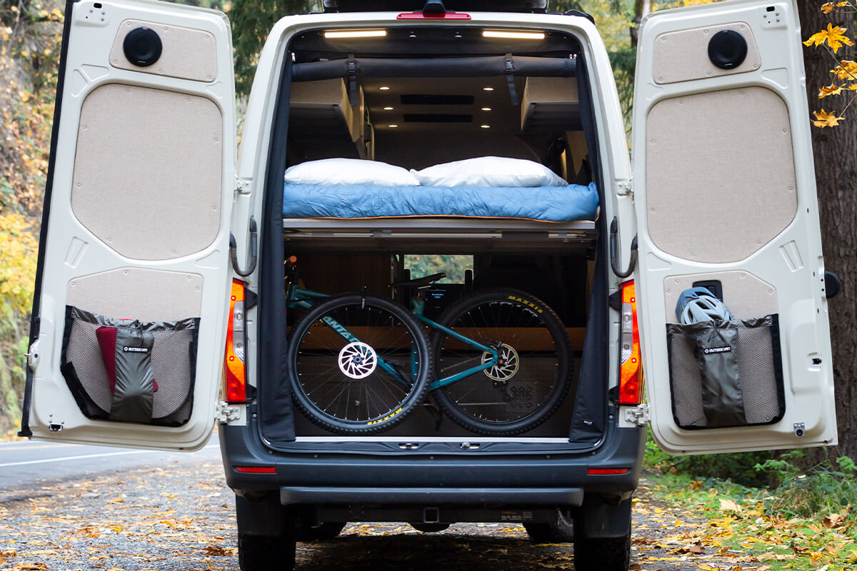 woodside is a 170 et custom Outside van conversion. seating for 3 and sleeping for 2. ext shower, galley and storage. great for mountain biking and luxury campying