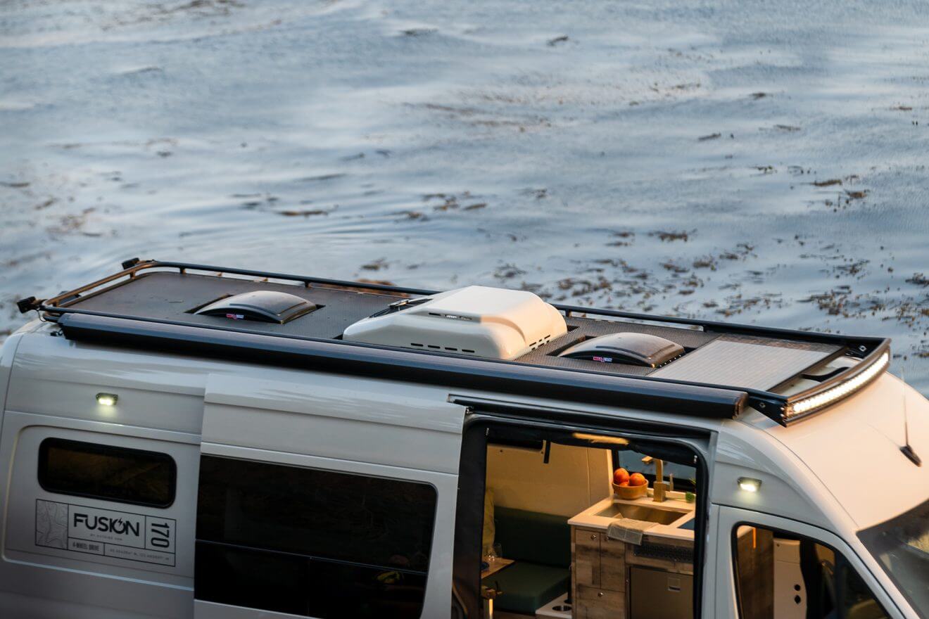 Safari roof rack with rooftop aftermarket air conditioner and 2 Maxxair roof vents
