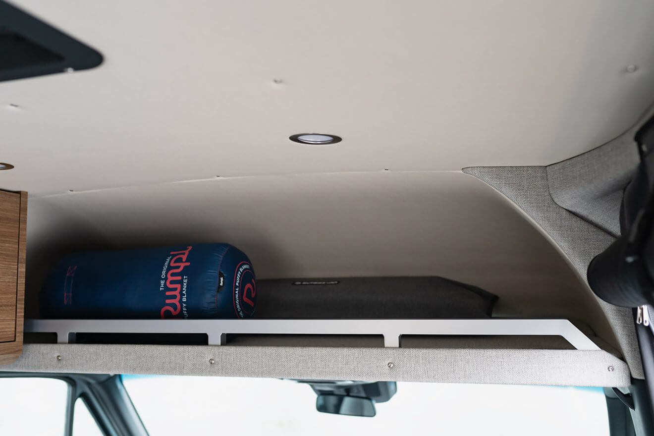 Overhead cab shelf stowing a rumpl blanket