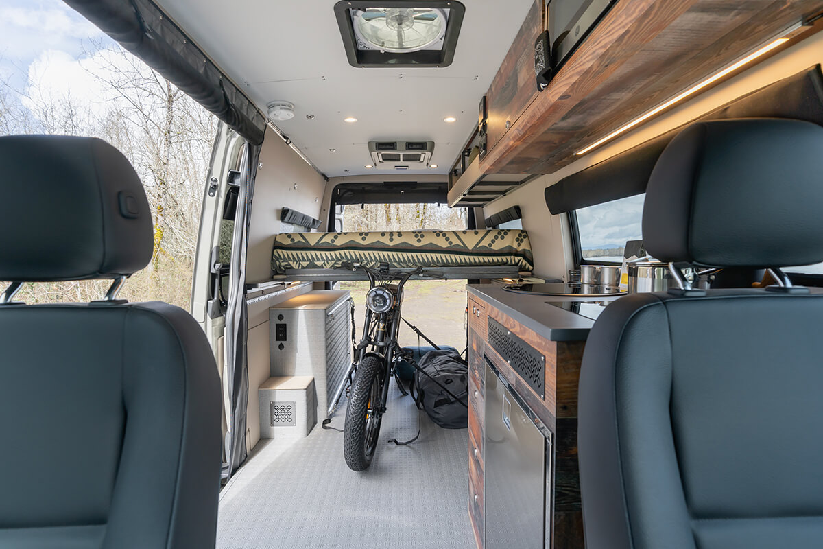 Interior of a van with an e-bike strapped down in the middle