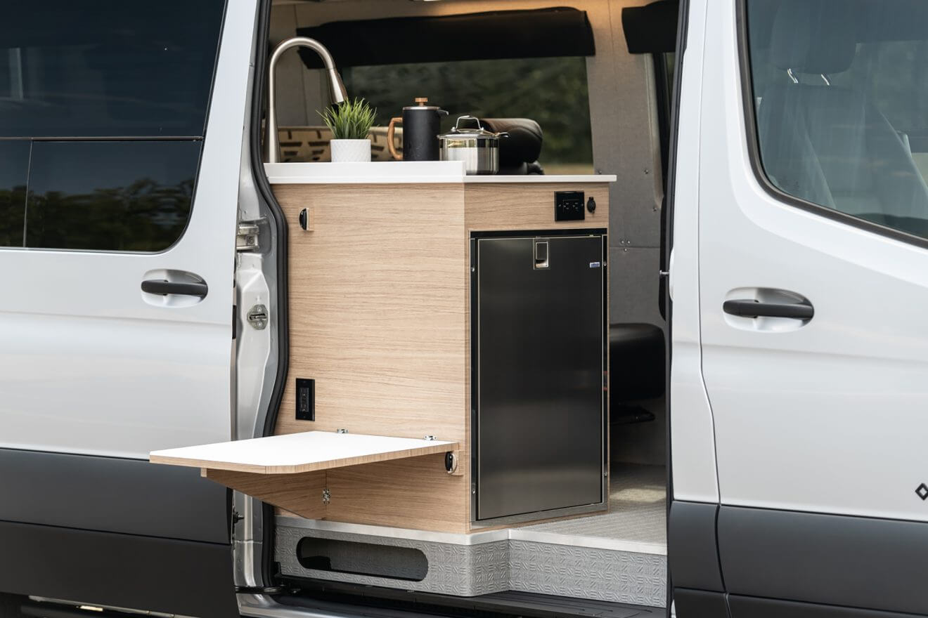 custom van conversion Loma 2021 mercedes benz sprinter 170 4wd seat four sleep three passenger slider door dropdown galley kitchen table