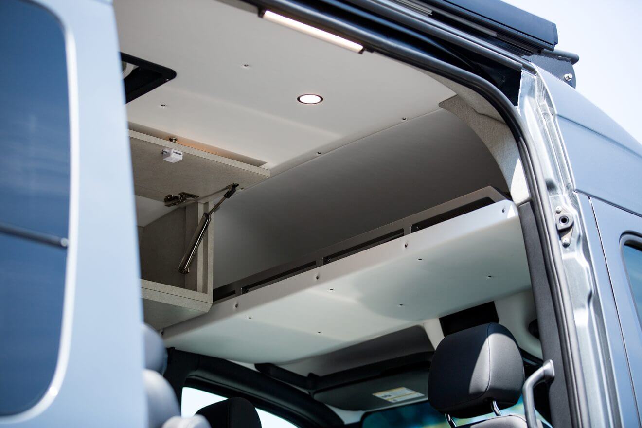 Detail of overhead cab shelf inside custom off road sprinter van