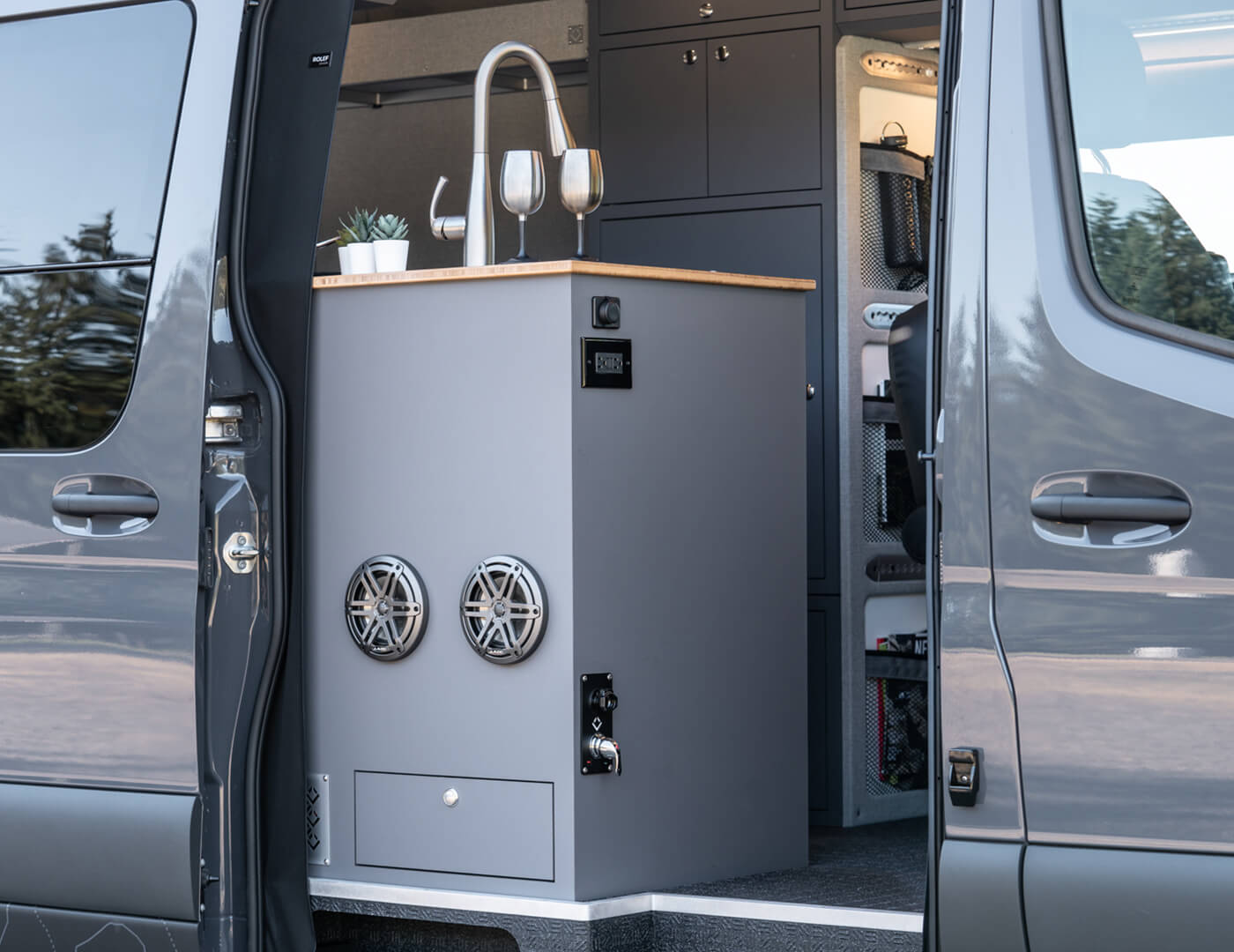 custom van conversion rucksack 2020 mercedes benz sprinter 170 4wd seat three sleep four passenger slider door galley kitchen slide out drawer