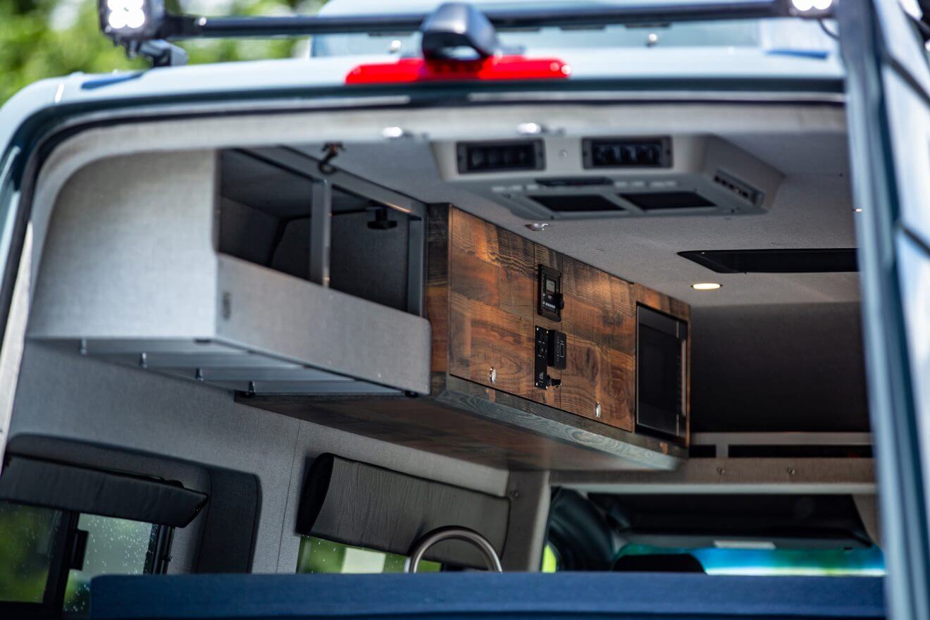 Detail of overhead shelves inside custom off road sprinter