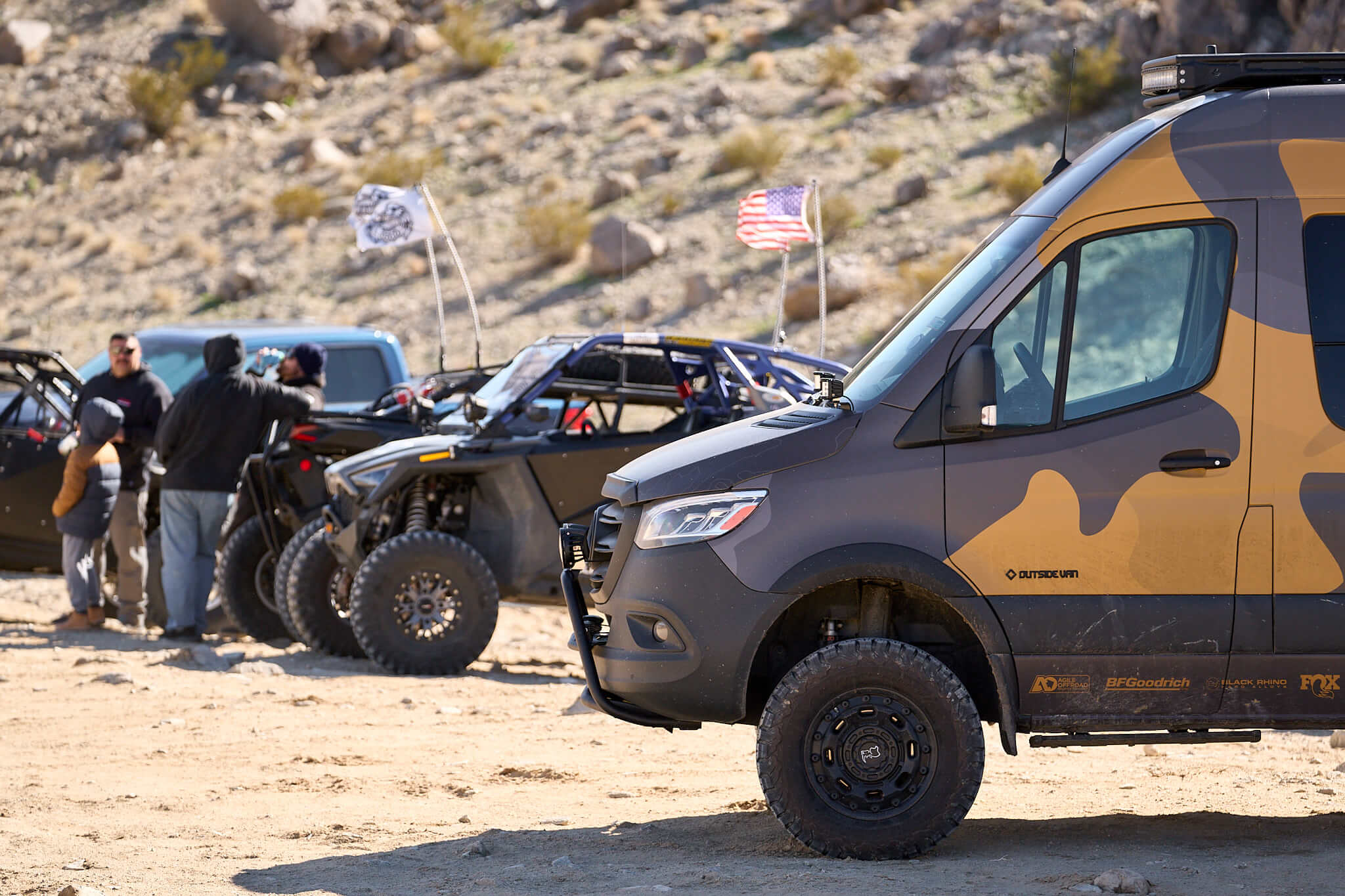 Outside Van parked next to side by sides and UTV's at King of the Hammers