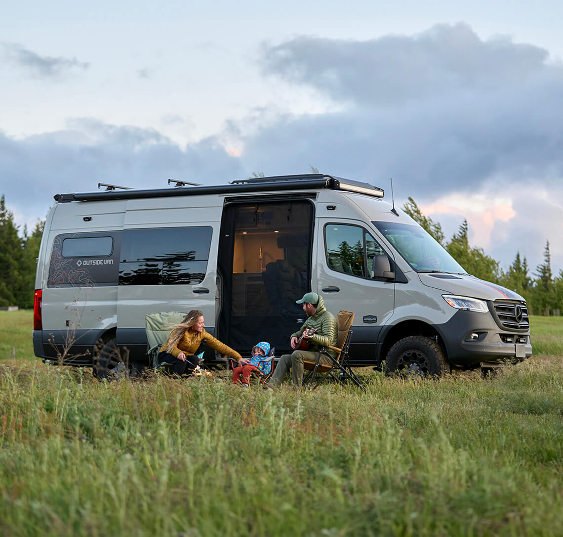 Family of three sitting outside Approach, a Sprinter 170 camper van