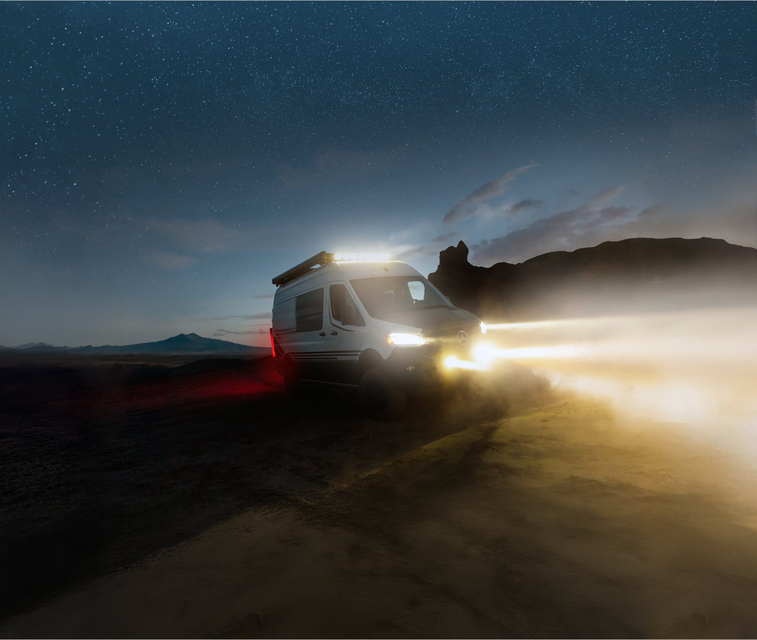 Storyteller Overland driving through the desert at night.