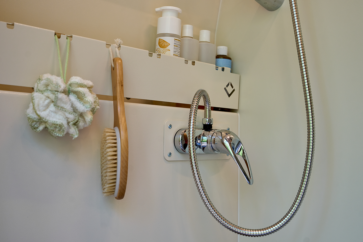 OutsideVan_Parks_Interior_OutbackWashroom_HighTopShowerDetail_Web copy Outside Van Parks Ranger HighTop ShowerBeyond the essentials, the Outback Washroom serves as a complete grooming station. We’ve integrated a dedicated vanity that brings the convenience of a home bathroom to the trail. Hand Washing Sink & Mirror: A sleek, permanent sink allows for quick cleanups and morning routines without occupying the kitchen galley. Integrated Storage: Keep your toiletries, towels, and essentials organized and tucked away in purpose-built storage compartments. Heater Outlet: To ensure the space remains a sanctuary year-round, a dedicated heater outlet pumps warm air directly into the washroom—perfect for drying out the space or keeping it cozy during winter expeditions.